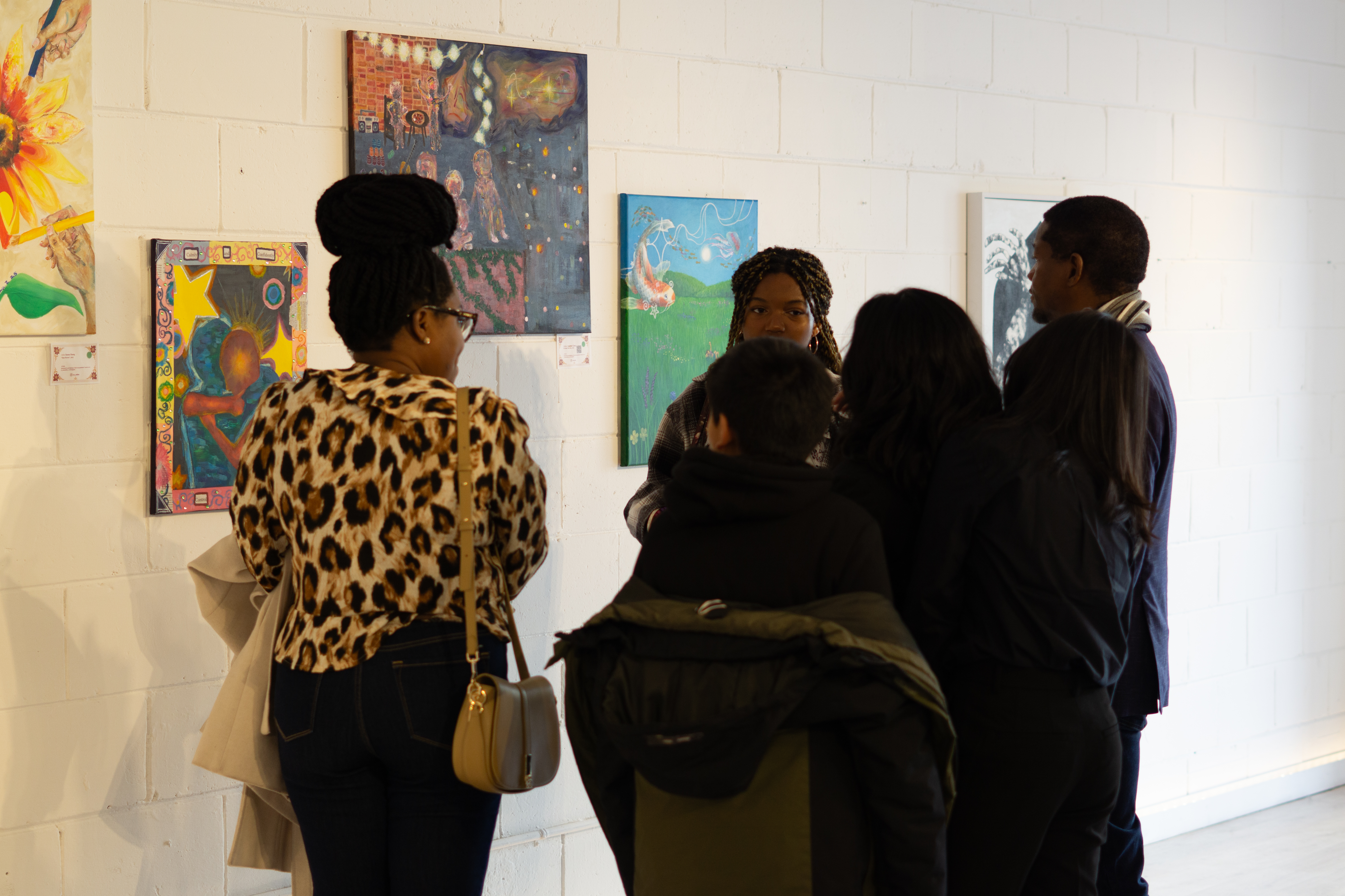 People in an art gallery looking at paintings