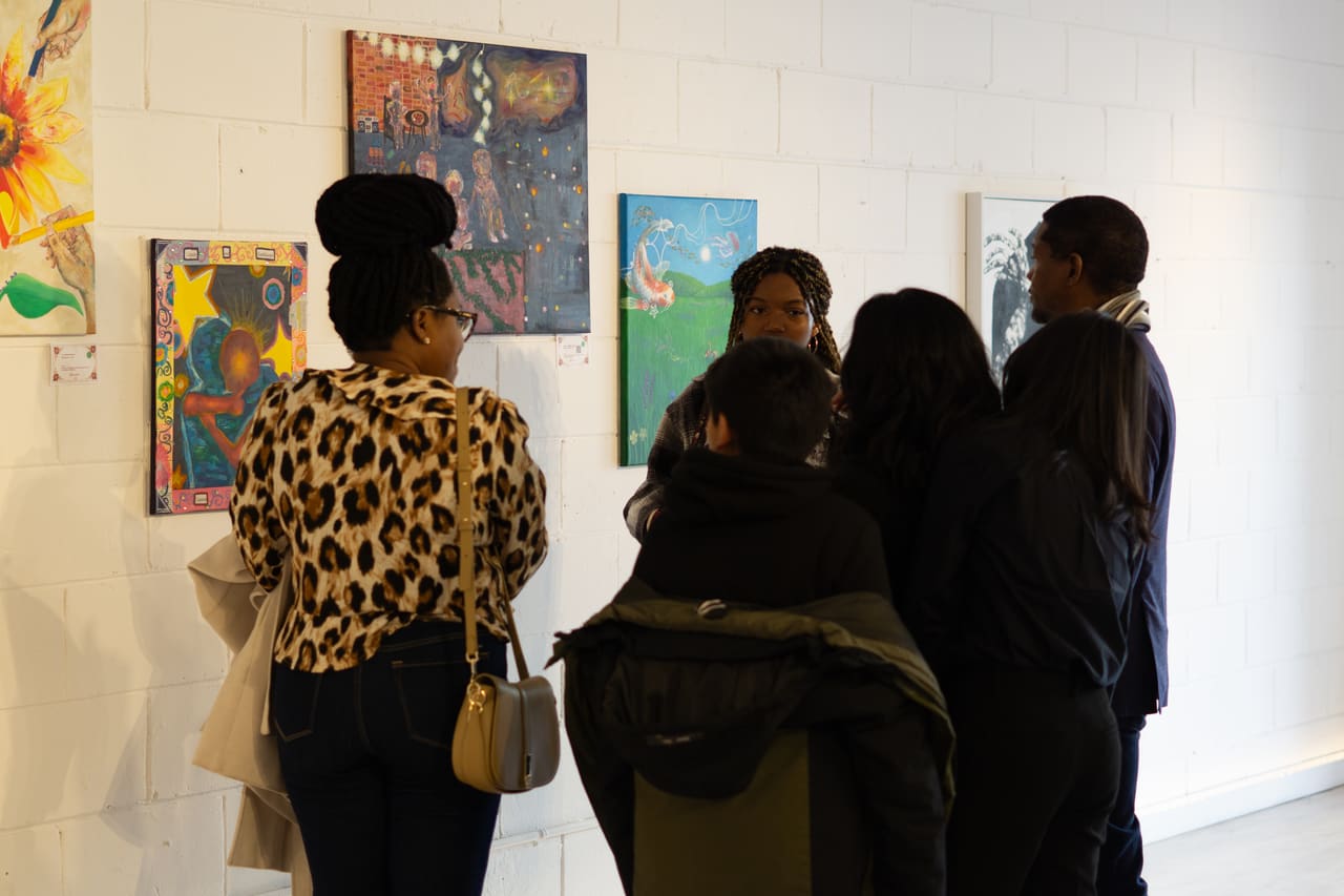 Visitors viewing artwork at a curated Antaraloka exhibition